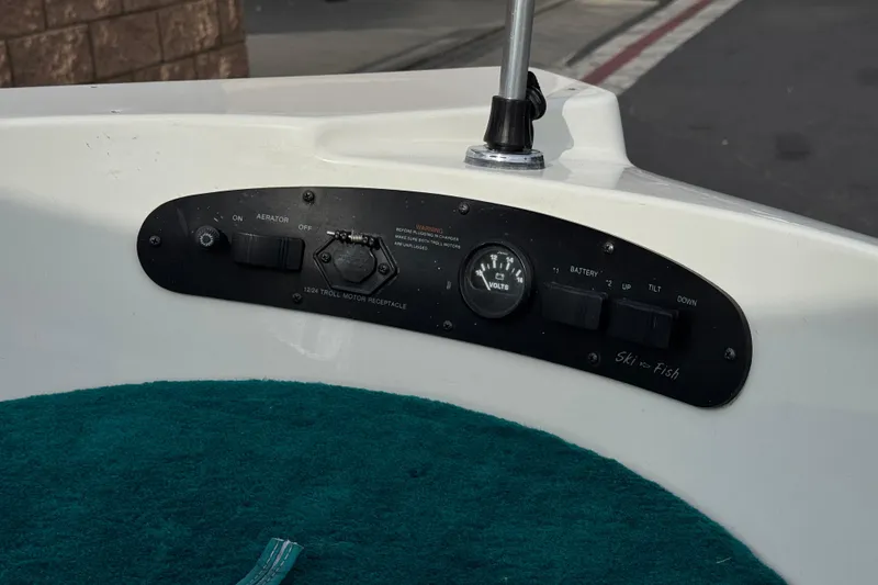 Slide: The Image of Control panel of a 1997 Glastron GS 185 boat with switches and voltmeter. - 11