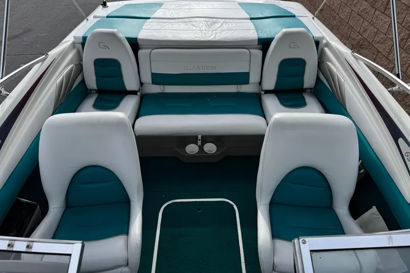 Slide: The Image of 1997 Glastron GS 185 boat interior with teal and white seating arrangement. - 12