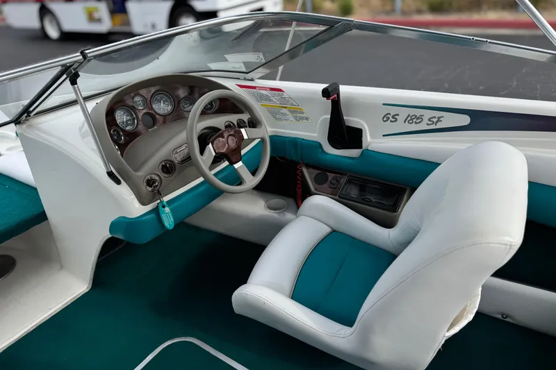 Slide: The Image of 1997 Glastron GS 185 boat interior with steering wheel and dashboard controls. - 19
