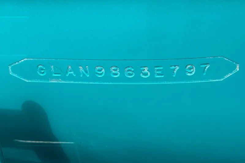 Slide: The Image of 1997 Glastron GS 185 boat hull identification number on teal surface. - 25