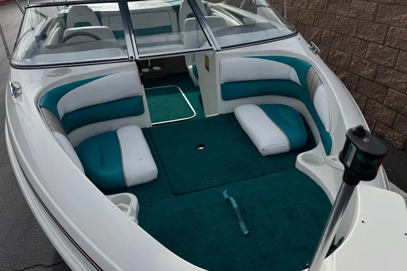 Slide: The Image of 1997 Glastron GS 185 boat interior with teal and white seating, open bow design. - 8