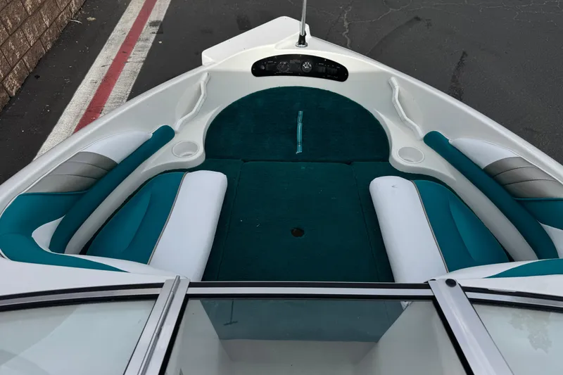 Slide: The Image of 1997 Glastron GS 185 boat interior with teal and white seating. - 9