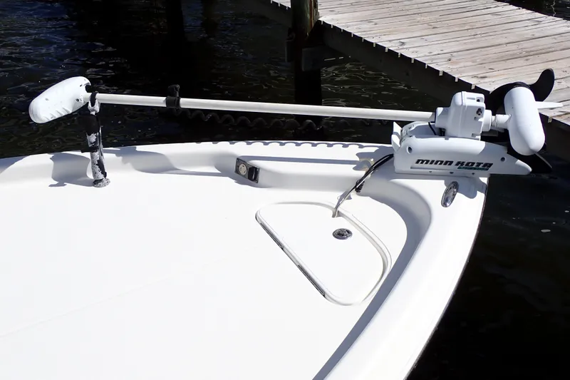 Slide: The Image of 2015 Blue Wave 2400 PureBay boat with Minn Kota trolling motor at dock. - 11