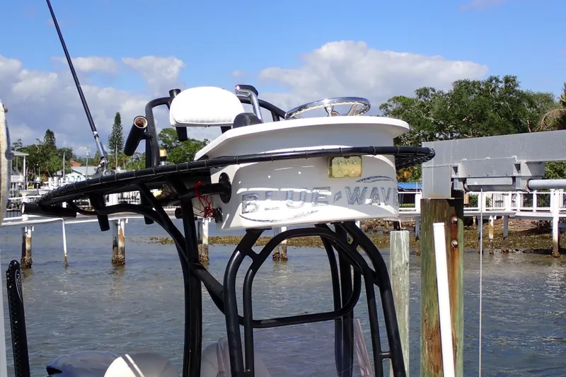 Slide: The Image of 2015 Blue Wave 2400 PureBay boat docked by waterfront with clear sky. - 12