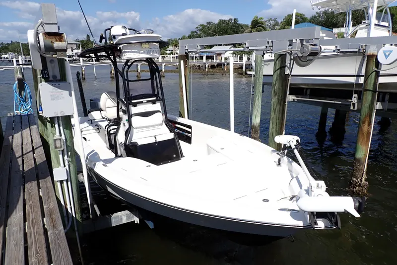 Slide: The Image of 2015 Blue Wave 2400 PureBay boat docked at marina, sunny day, calm waters. - 3