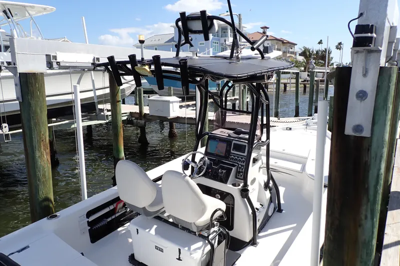 Slide: The Image of 2015 Blue Wave 2400 PureBay boat docked, featuring dual seats and advanced navigation equipment. - 4