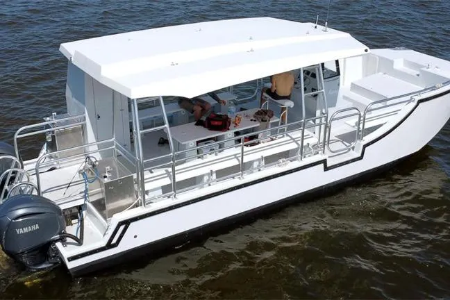 The Image of Custom BYD 34 boat, 2027 model, on water with Yamaha engine, featuring spacious deck. - 1