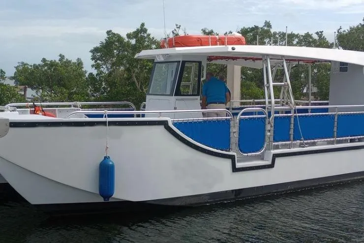 Slide: The Image of Custom BYD 34 boat, 2027 model, docked with blue accents and safety equipment. - 10