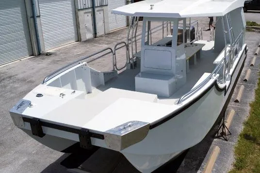 Slide: The Image of Custom BYD 34 boat, 2027 model, docked outdoors with sleek white design. - 3