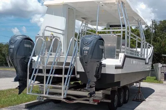 Slide: The Image of Custom BYD 34 boat, 2027 model, with dual Yamaha 250 V6 engines on a trailer. - 6