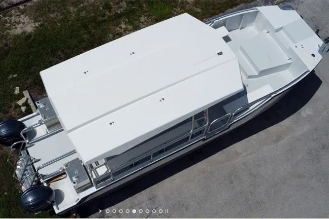 Slide: The Image of Aerial view of a 2027 Custom BYD 34 boat with dual outboard motors. - 7