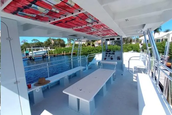 Slide: The Image of Custom BYD 34 boat interior, 2027 model, featuring spacious seating and control panel by the water. - 8