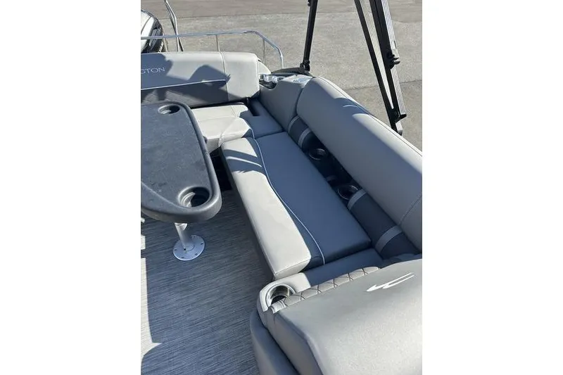Slide: The Image of 2022 Bennington 20 SLMX boat with outboard motor in parking lot. - 12