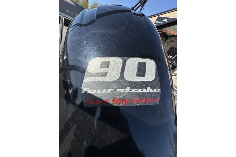 Slide: The Image of 2022 Bennington 20 SLMX pontoon boat with Yamaha outboard motor in a parking lot. - 3