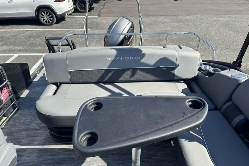 Slide: The Image of 2022 Bennington 20 SLMX pontoon boat with outboard motor in a parking lot. - 4