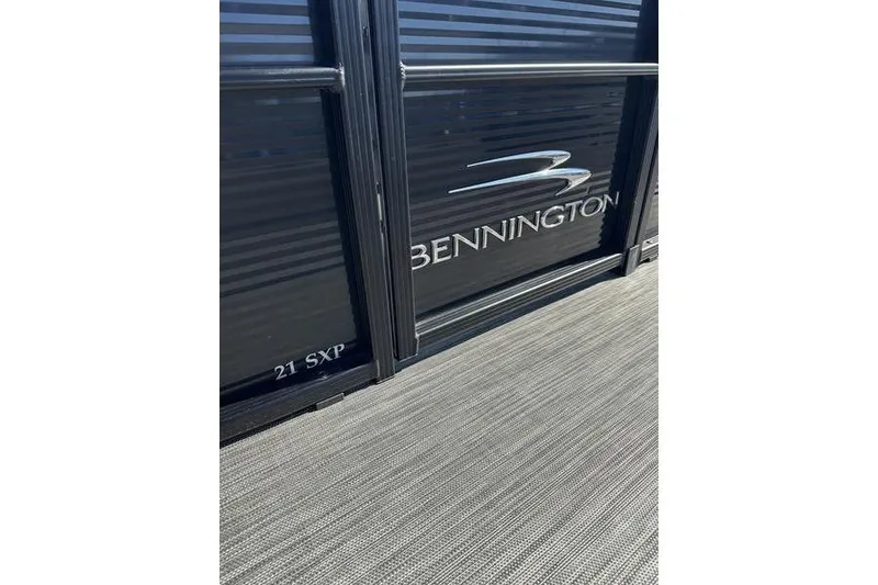 Slide: The Image of 2022 Bennington 20 SLMX pontoon boat with gray seating and spacious deck layout. - 6