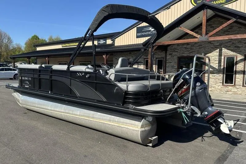 Slide: The Image of 2022 Bennington 20 SLMX pontoon boat interior with gray seating and central table. - 8