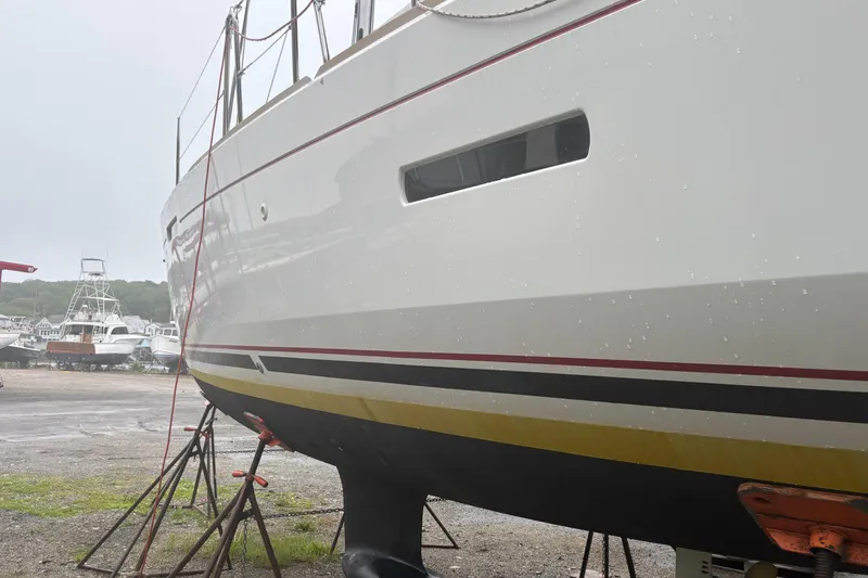 Slide: The Image of 2017 Jeanneau Sun Odyssey 389 sailboat on stands, side view in a boatyard. - 15