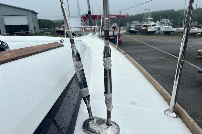 Slide: The Image of 2017 Jeanneau Sun Odyssey 389 sailboat deck with rigging, in a marina setting. - 22