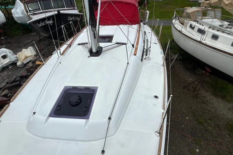 Slide: The Image of 2017 Jeanneau Sun Odyssey 389 sailboat on land, surrounded by other boats. - 25