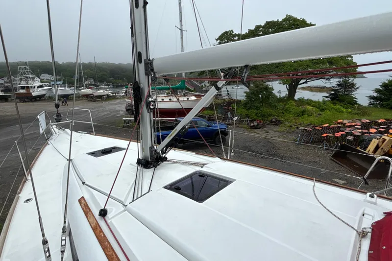 Slide: The Image of 2017 Jeanneau Sun Odyssey 389 sailboat on land, surrounded by trees and other boats. - 27