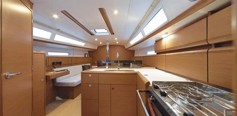 Slide: The Image of Manufacturer Provided Image: Interior of 2017 Jeanneau Sun Odyssey 389 sailboat with modern kitchen and seating area. - 37