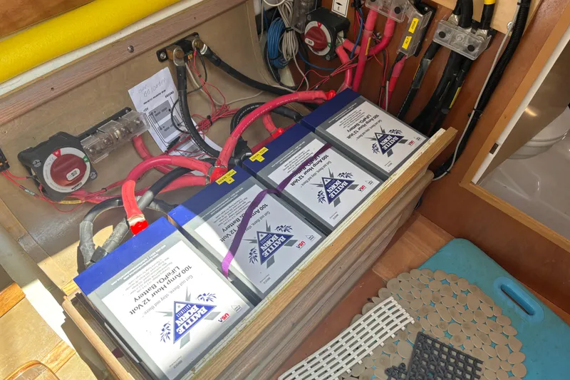 Slide: The Image of Battery compartment of a 2017 Jeanneau Sun Odyssey 389 sailboat, showing wiring and connections. - 61