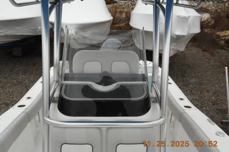 Slide: The Image of 2021 Sea Fox 228 Commander boat interior with console and seating, parked outdoors. - 12