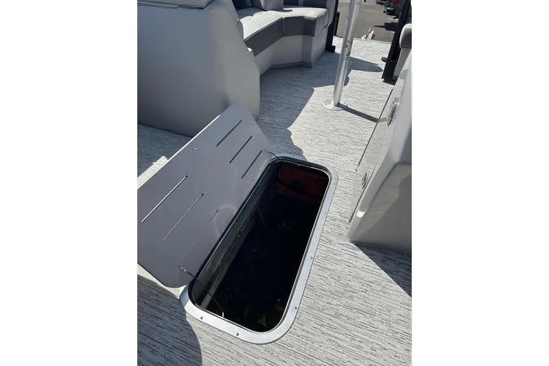 Slide: The Image of 2022 Bennington 22 LSR boat interior with open storage compartment on deck. - 11