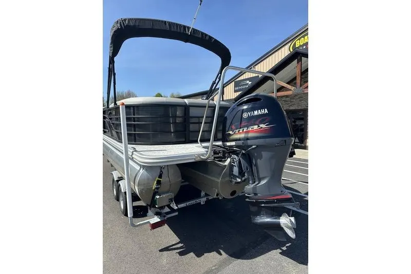 Slide: The Image of 2022 Bennington 22 LSR pontoon boat with Yamaha outboard motor, parked on trailer. - 15