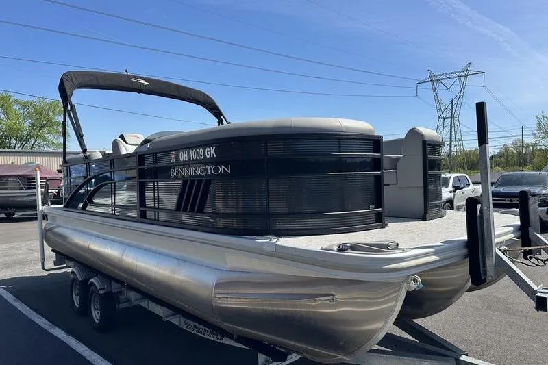 Slide: The Image of 2022 Bennington 22 LSR pontoon boat on trailer in parking lot. - 4