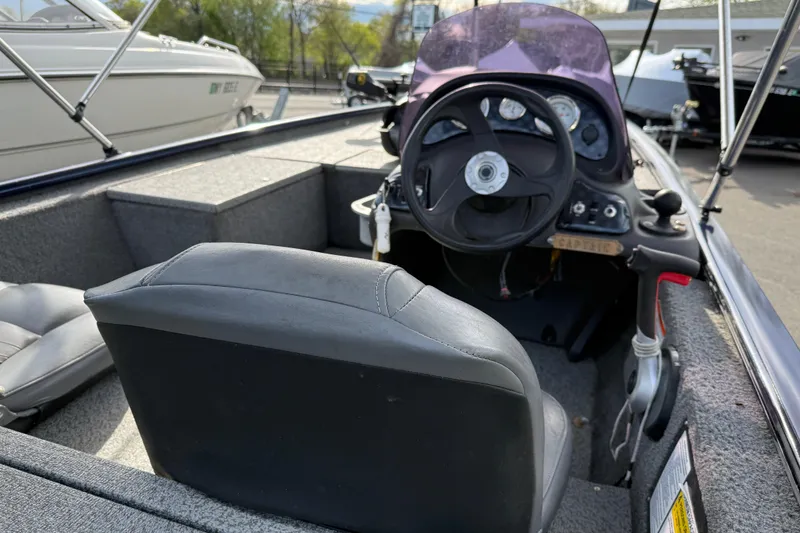 Slide: The Image of 2019 Bass Tracker Pro 17 boat interior with steering wheel and captain's seat. - 10