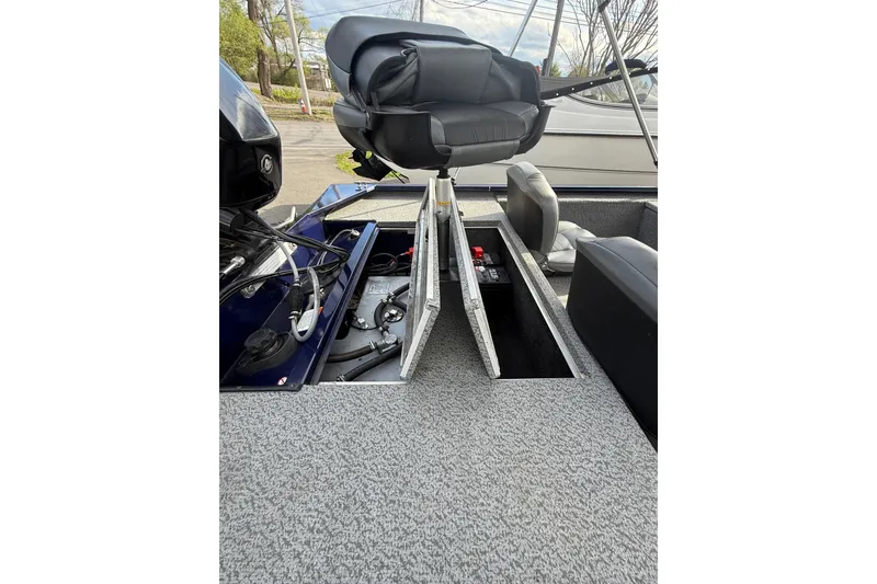 Slide: The Image of 2019 Bass Tracker Pro 17 boat interior with open storage compartments and seating. - 3