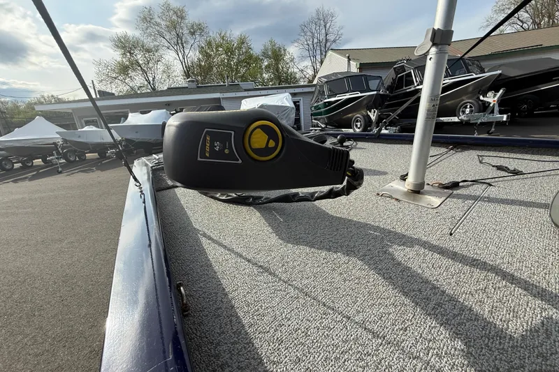 Slide: The Image of 2019 Bass Tracker Pro 17 boat deck with trolling motor, parked outdoors. - 6