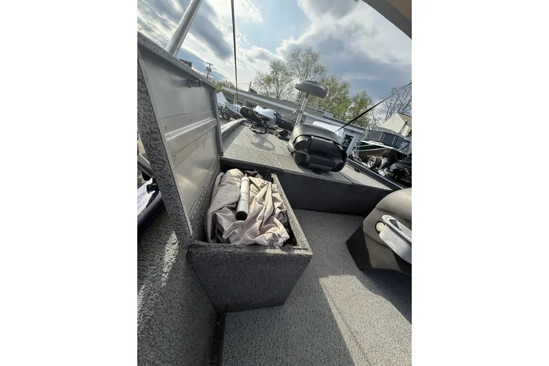 Slide: The Image of 2019 Bass Tracker Pro 17 boat interior with open storage compartment and seating. - 7