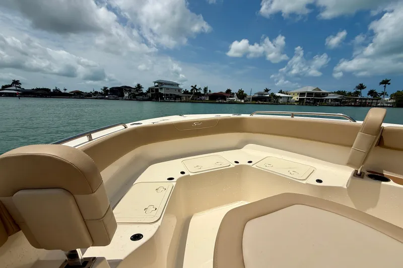 Slide: The Image of 2023 Scout 215 XSF boat interior with seating, on a sunny day by the water. - 11