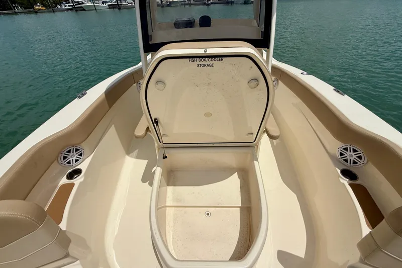 Slide: The Image of 2023 Scout 215 XSF boat with open fish box cooler storage on deck. - 13