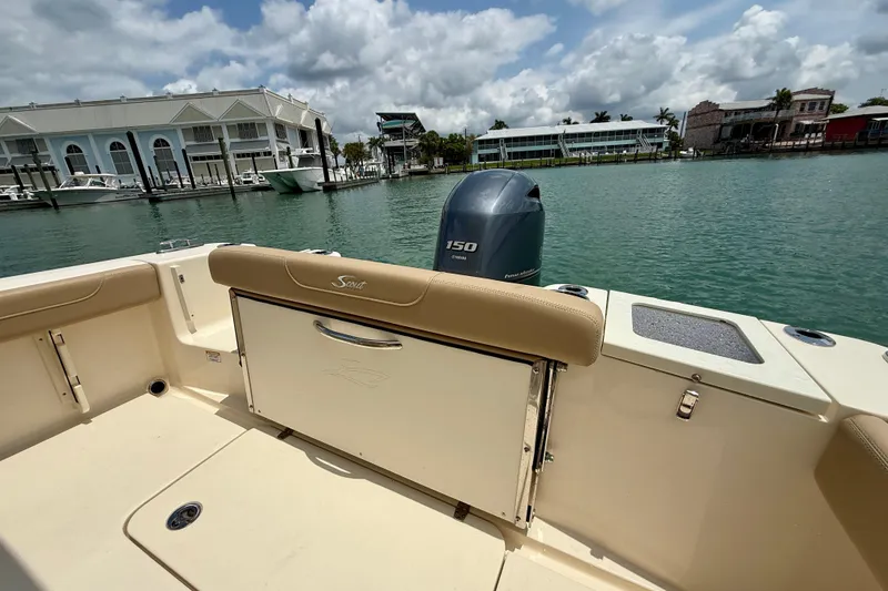 Slide: The Image of 2023 Scout 215 XSF boat interior with Yamaha 150 engine, dockside view. - 21
