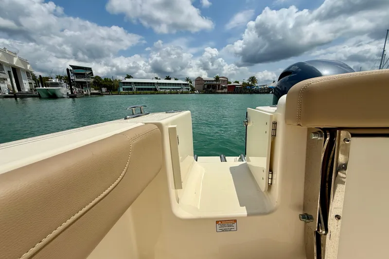 Slide: The Image of 2023 Scout 215 XSF boat interior with waterfront view and cloudy sky. - 23