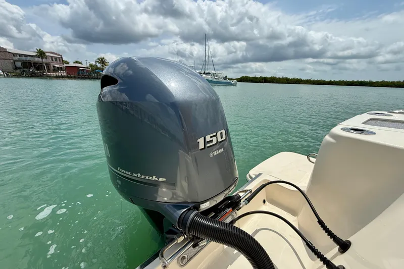 Slide: The Image of 2023 Scout 215 XSF boat with Yamaha 150 four-stroke engine on calm water. - 26