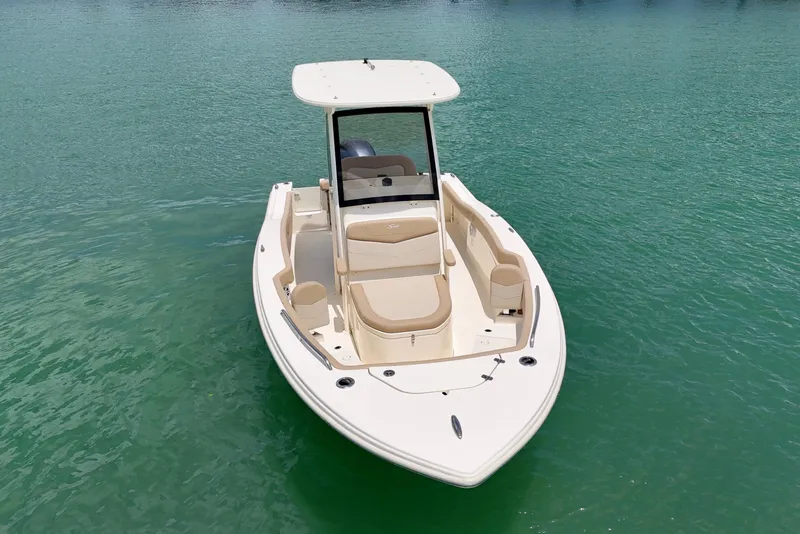Slide: The Image of 2023 Scout 215 XSF boat on calm turquoise water. - 3