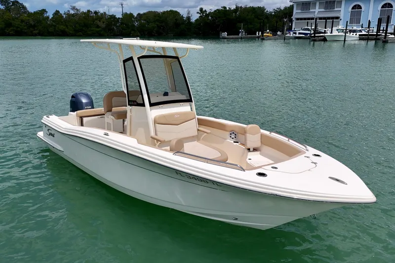 Slide: The Image of 2023 Scout 215 XSF boat on calm water, featuring sleek design and modern amenities. - 4