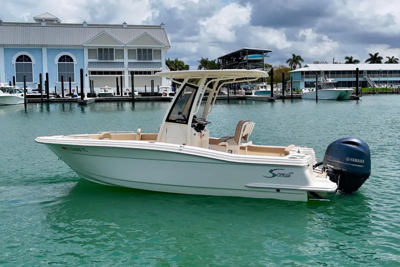 Slide: The Image of 2023 Scout 215 XSF boat with Yamaha engine on turquoise water near marina. - 5