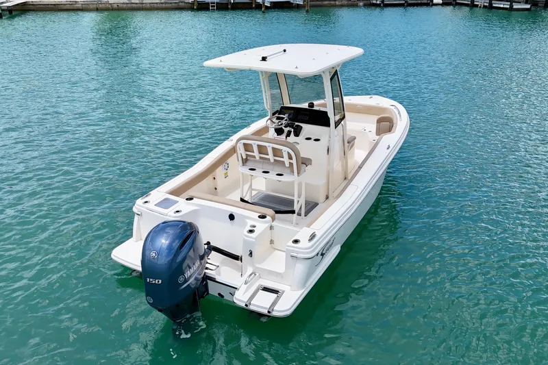 Slide: The Image of 2023 Scout 215 XSF boat with Yamaha outboard engine on clear water. - 6