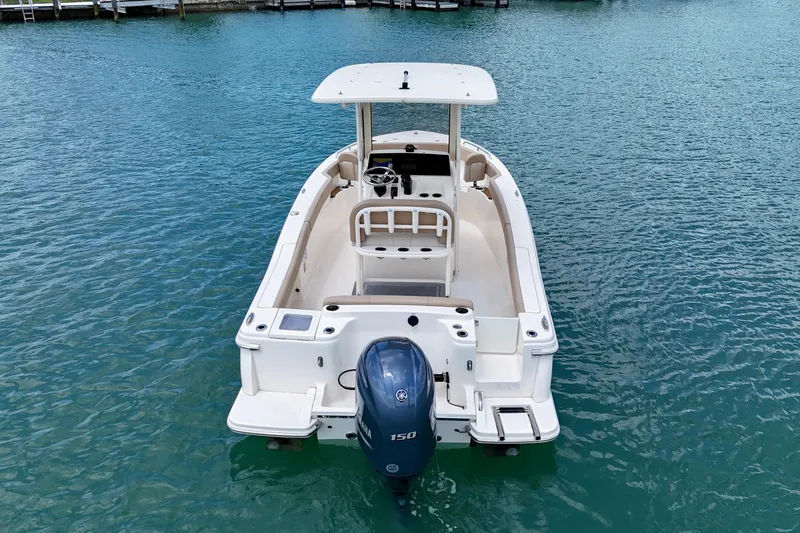 Slide: The Image of 2023 Scout 215 XSF boat on clear blue water, rear view. - 7