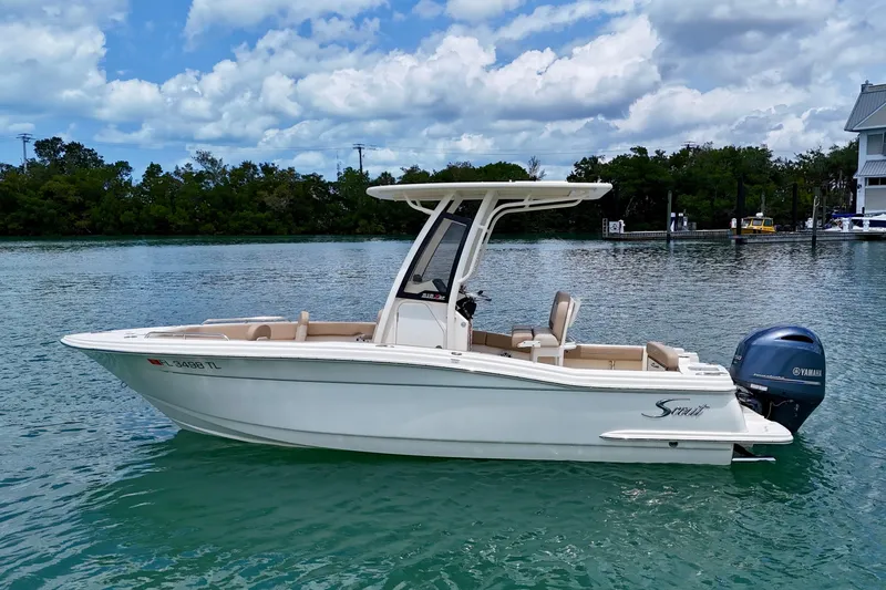 Slide: The Image of 2023 Scout 215 XSF boat on calm water, featuring sleek design and Yamaha outboard motor. - 9