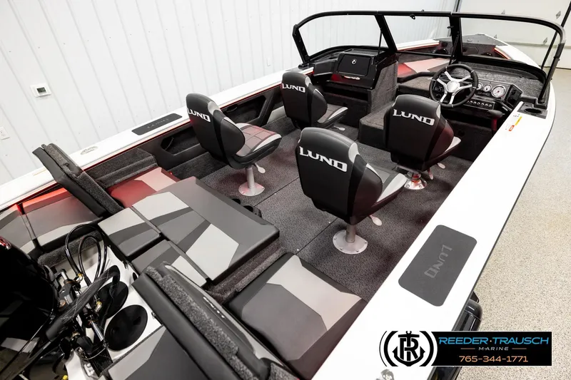 Slide: The Image of 2026 Lund 1875 Crossover XS boat interior with seating and steering console. - 10