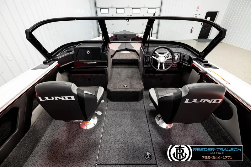 Slide: The Image of 2026 Lund 1875 Crossover XS boat interior with dual seats and steering console. - 12