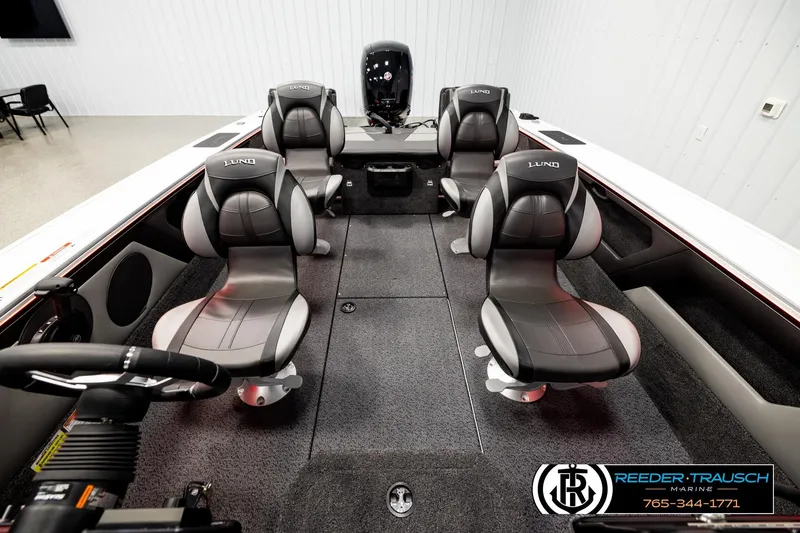 Slide: The Image of 2026 Lund 1875 Crossover XS boat interior with four black seats and steering wheel. - 15