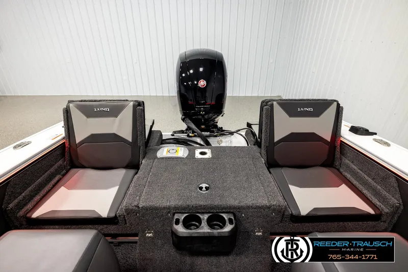 Slide: The Image of 2026 Lund 1875 Crossover XS boat interior with seating and motor, showcased by Reeder-Trausch Marine. - 18